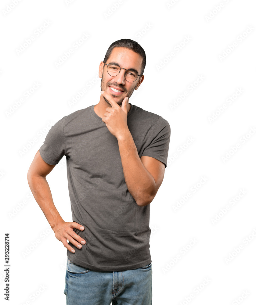 Happy young man making a gesture of doubt Happy young man making a gesture of doubt