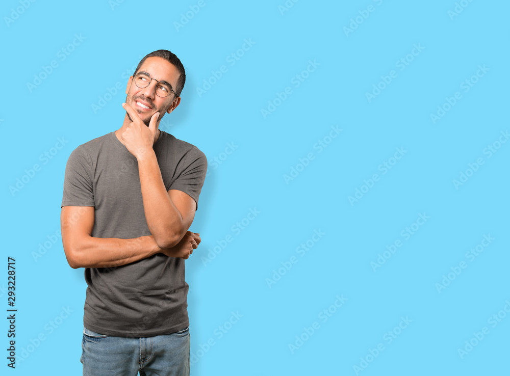 Happy young man making a gesture of doubt Happy young man making a gesture of doubt