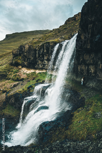 The couple are enjoying the view in wonderfull  waterfall on Iceland