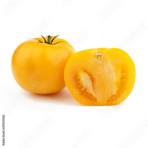 Yellow whole tomato with a slice. Isolated on white background. 