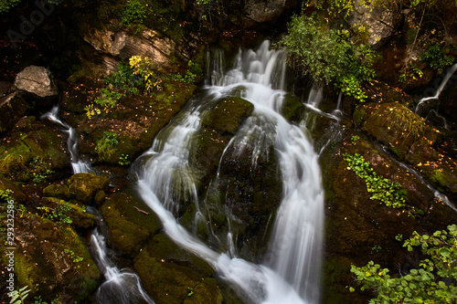 Water cascade between the rocks of a river