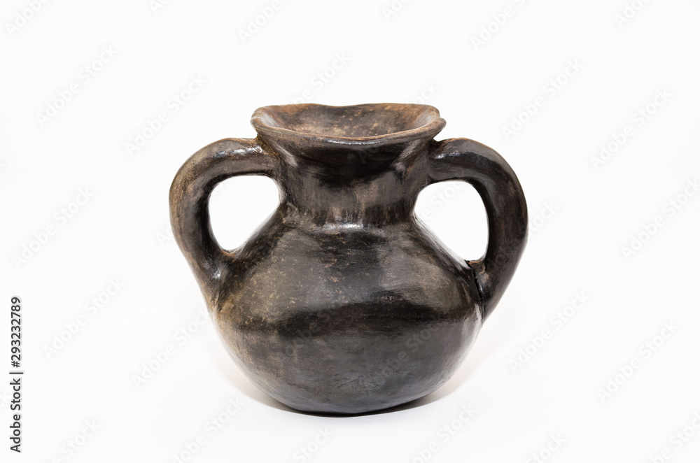 Old black clay amphora on a white background Old black clay amphora on a white background