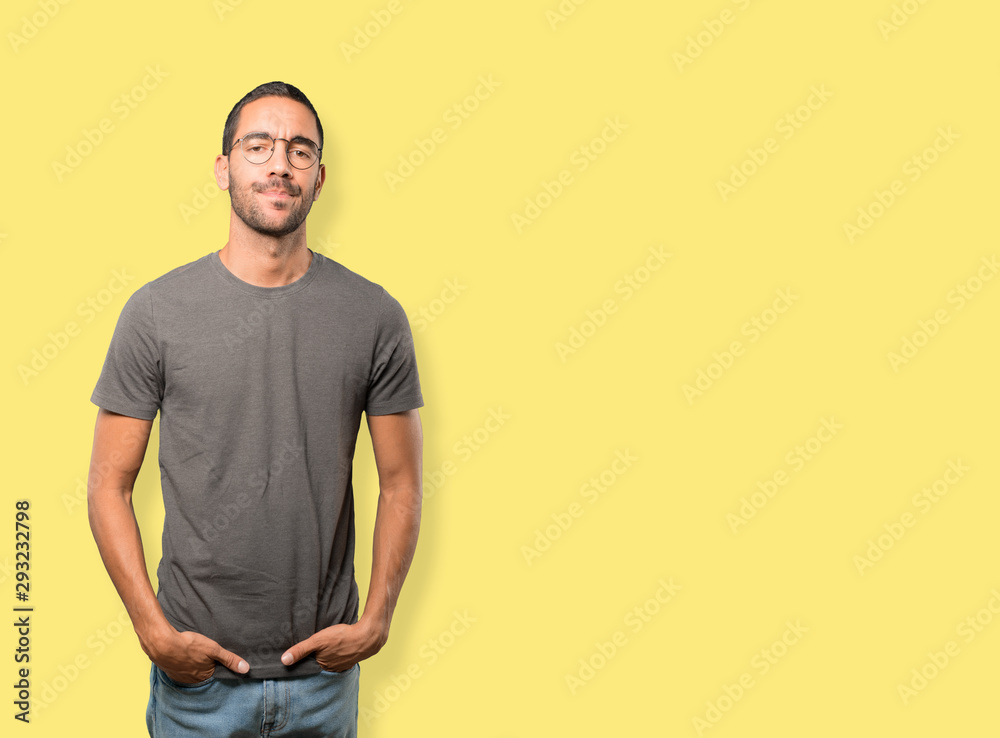 Fototapeta premium Serious young man looking up gesture