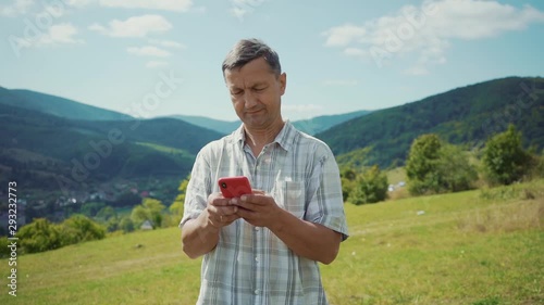 Close up man in the mountains use phone technology a concept of connection with friends and family mobile modern smartphone work cell device internet male smart travel slow motion