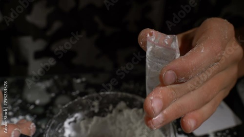 White drug powder packaged in plastic bags. Hands of a minor child
