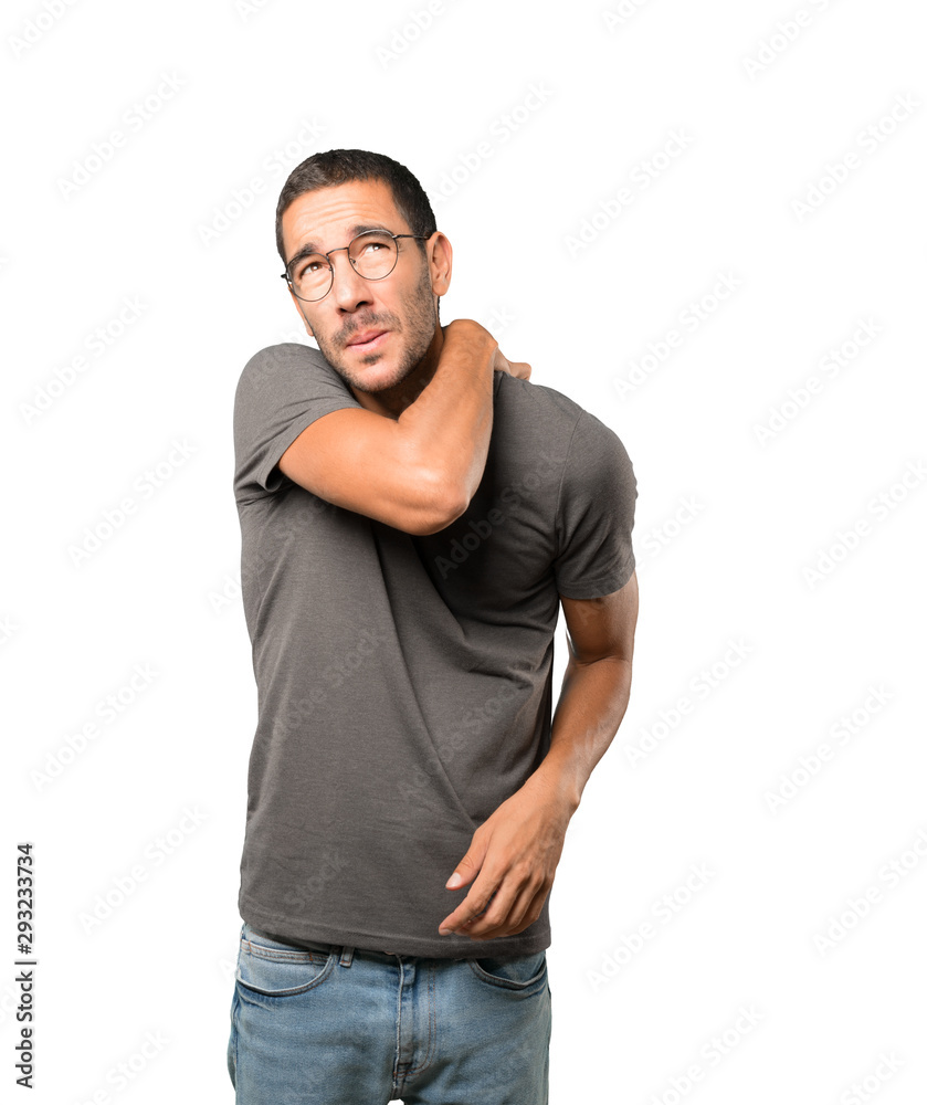 Concerned young man making a scratching gesture Concerned young man making a scratching gesture