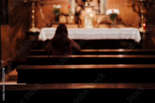 unrecognizable Woman Sitting in Church praying. Religion Concept. Back view © Eva