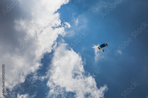 Parachute jumper in front of clouds