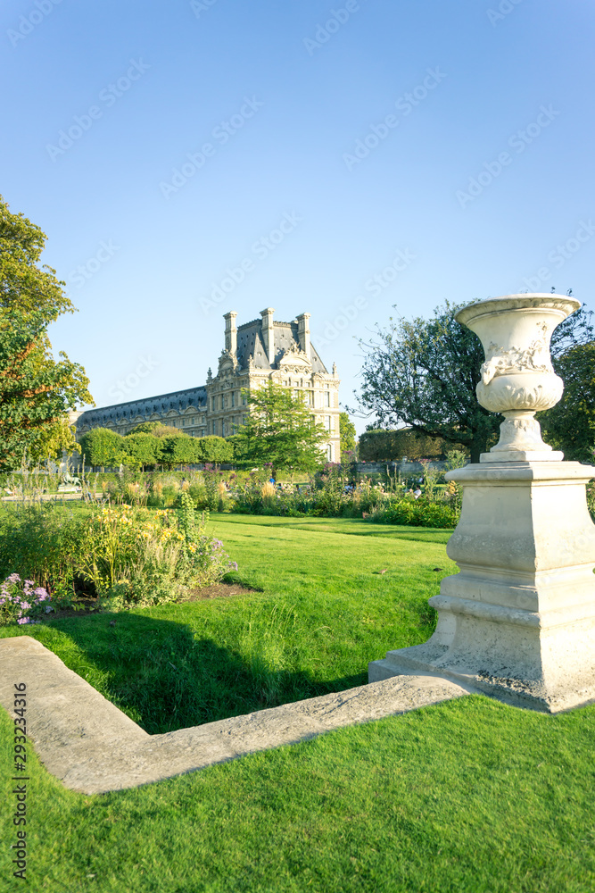 Summer in Tuileries garden with Louvre school in the background, Paris, France.