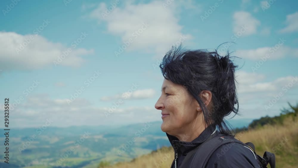Close up happy woman walk in mountains with backpack on sunny day travel female hike leisure people summer forest green healthy lifestyle trip close up slow motion