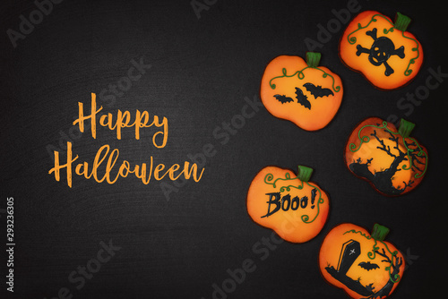 Halloween cookies in the shape of a pumpkin on a black background
