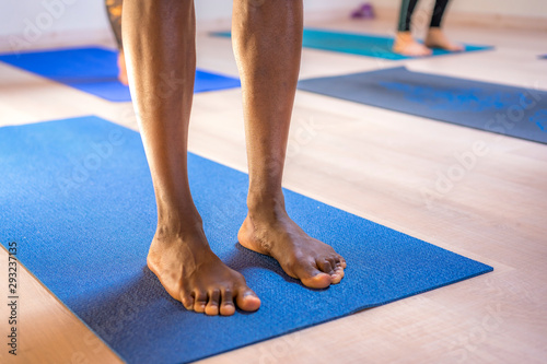 Hendaye  France     July 2019  Yoga session  legs of a colored man in the middle of yoga class
