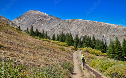 Hiker near Colorado's Hoosier Pass with 14,000-foot Quandary Peak in the background. photo