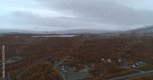 Kilpisjarvi town, Aerial, reverse, drone shot, overlooking the village,  first snow on the ground, on a cold autumn morning, in Enontekio, Kilpisjarvi, Finland photo