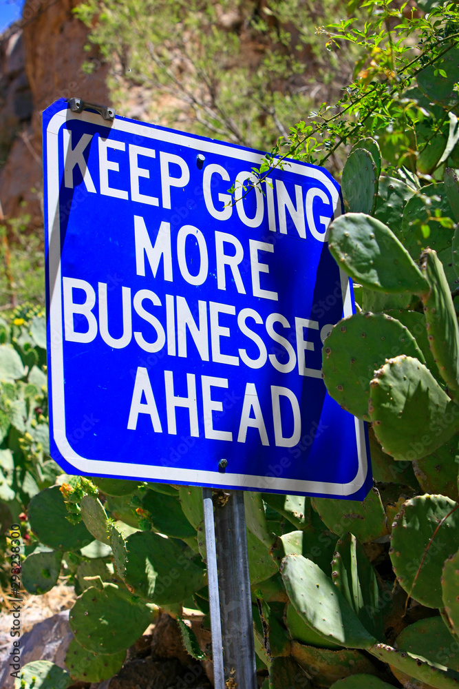 Keep Going More Businesses Ahead blue and white sign