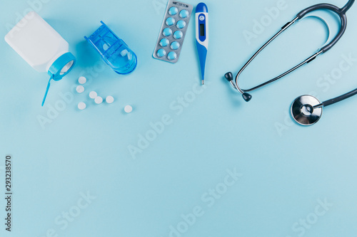 Medical equipment and pills on a blue background