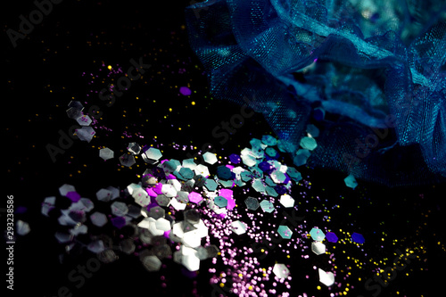 Over head view of a confetti covered table top with party gift bag.