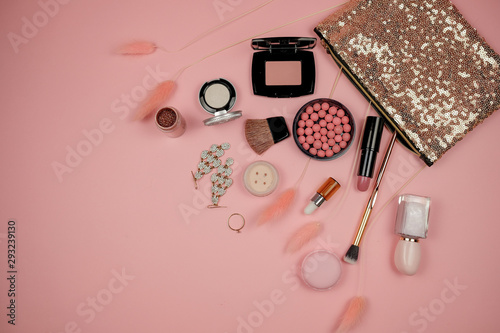 Makeup cosmetic with beauty bag on pink background. lipstick, brush, eye shadow and accessories. woman fashion.