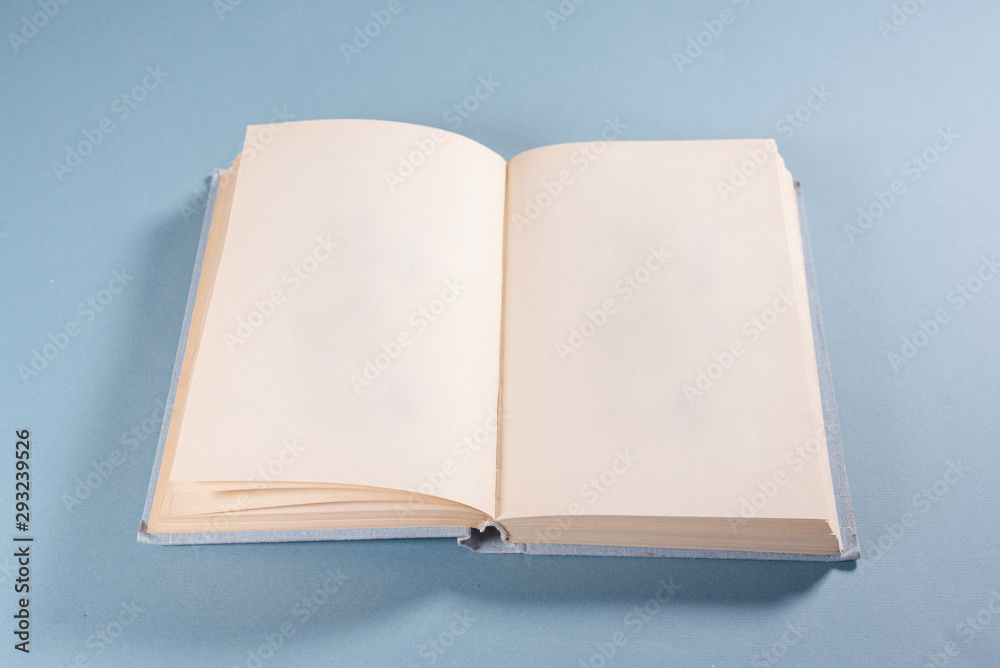 Book with a blank pages with copy space on blue background.