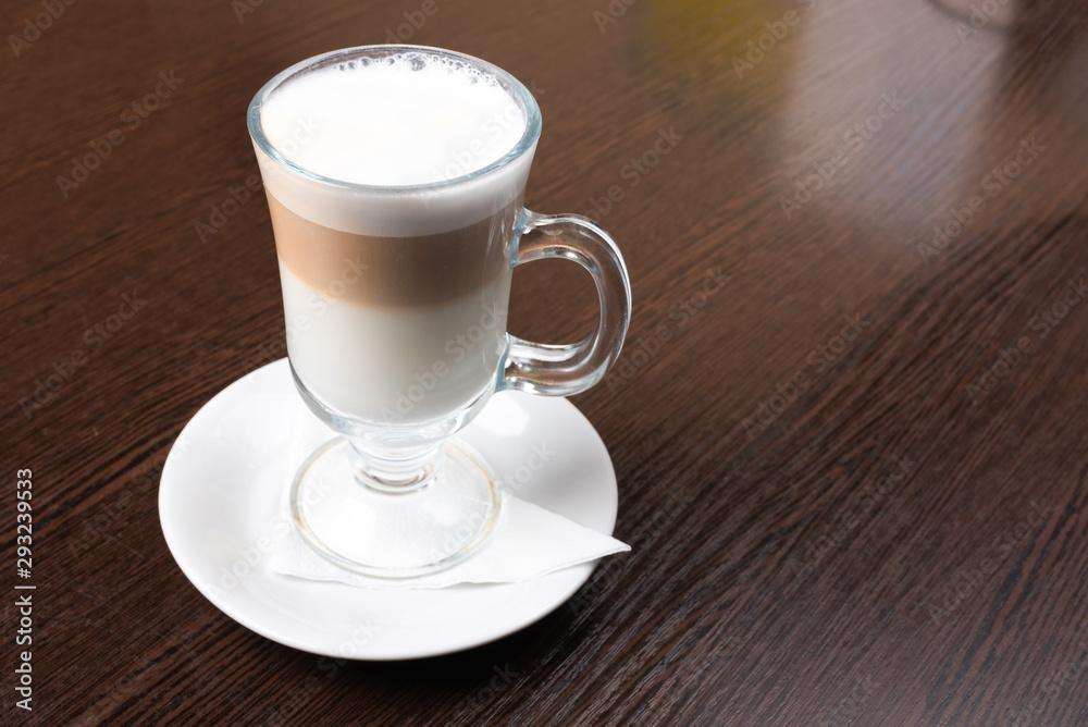 Mug of latte, on a dark, wooden background. Mug of latte, on a dark, wooden background.