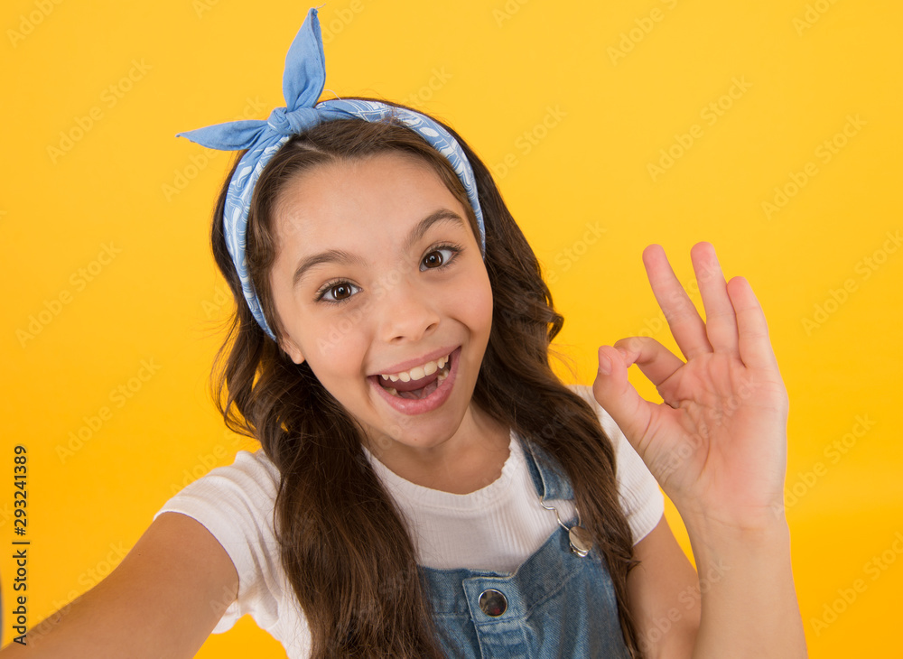 Its ok. Happy little child with ok hand on yellow background. Small girl smiling with ok gesture. Ok sign. Nonverbal language communication Its ok. Happy little child with ok hand on yellow background. Small girl smiling with ok gesture. Ok sign. Nonverbal language communication