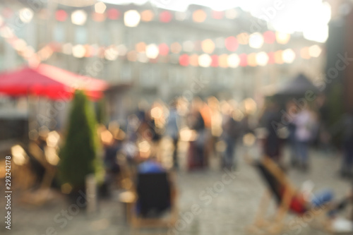 Fototapeta Naklejka Na Ścianę i Meble -  Defocused people at the street festival in the sunny day