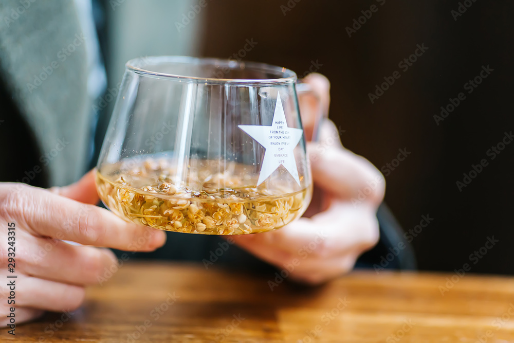 The girl is holding herbal tea. a cup of linden tea The girl is holding herbal tea. a cup of linden tea