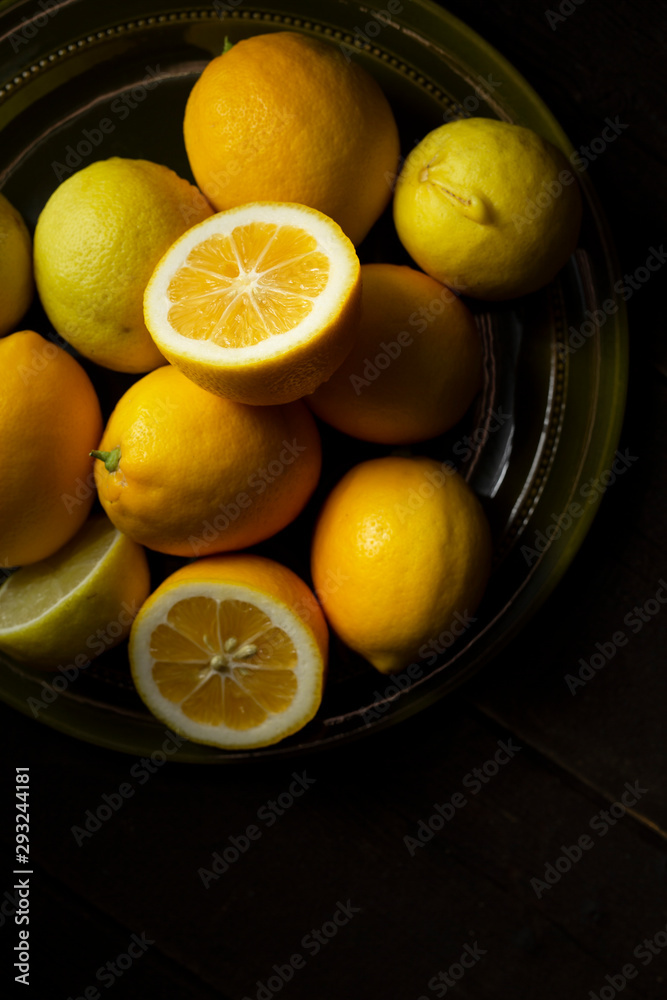 Home grown lemons on an olive green plate. Home grown lemons on an olive green plate.