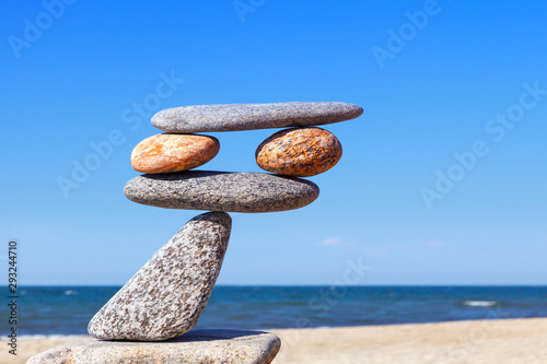 Balanced Rock Zen on the background of the sea. The concept of fall risk and unstable equilibrium.