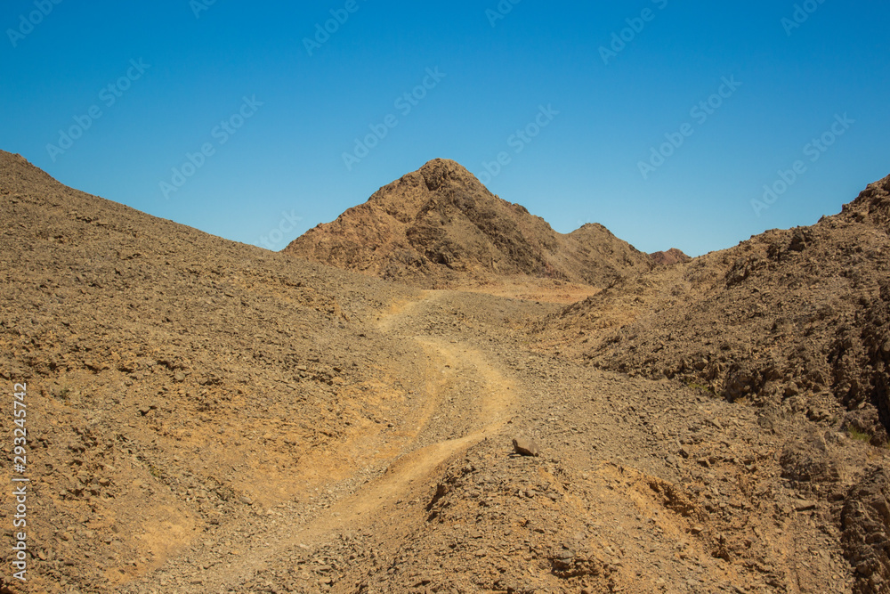 lonely trail to desert mountain peak idyllic scenery landscape travel photography with empty copy space for text  