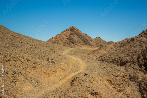 lonely trail to desert mountain peak idyllic scenery landscape travel photography with empty copy space for text 