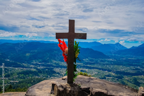 mirador el granizo con una cruz con flores mirando al gran valle de cajola y de los altos de quetzaltenango, con las montañas e volcanes que la rodean  photo