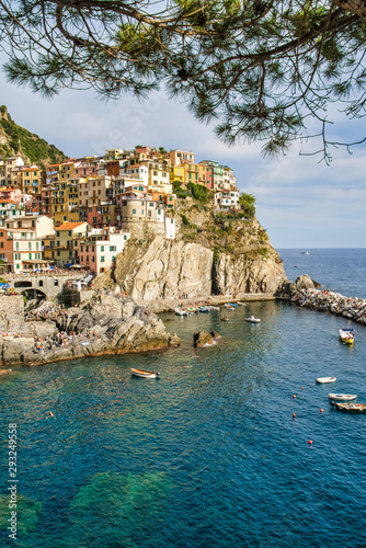 Obraz na płótnie Beautiful view of colorful residential buildings and a bay with boats in the village of Manarola, Italy, National Park of the Cinque Terre w salonie