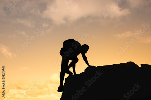 Determined man climbing up mountain. Life goals, and inspiration concept. 