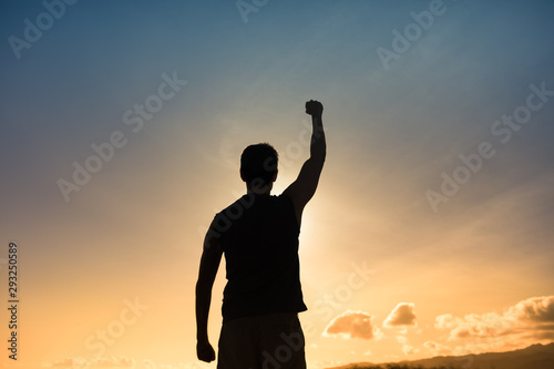 Strong confident muscular Male with fist in the air. 