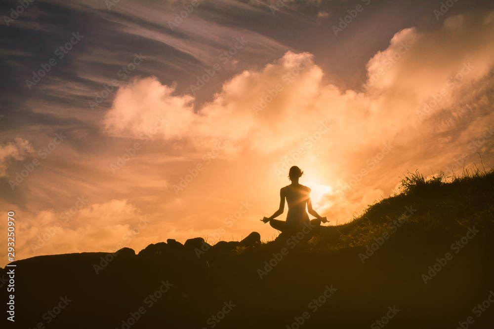 Meditation on a mountain at sunrise 