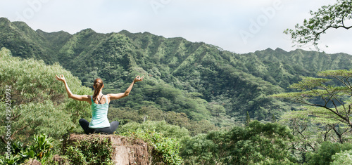 Woman practicing peace and meditation in green mountain Vally.