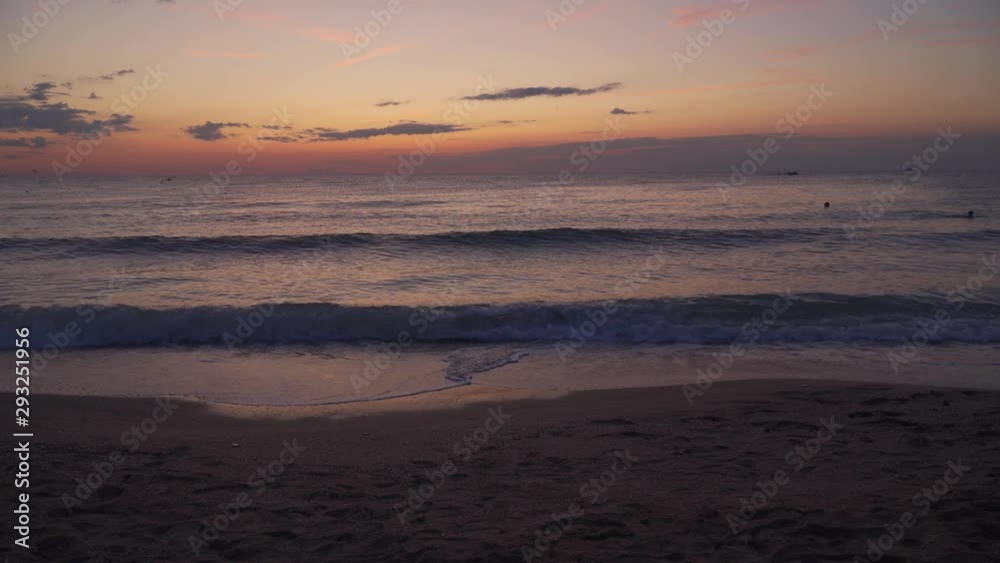Sunset view from beach, waves crashing on sand beach. Sunset view from beach, waves crashing on sand beach.