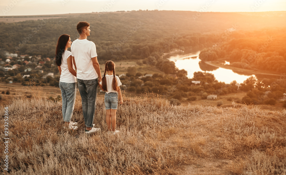 Supportive family standing in countryside in evening Supportive family standing in countryside in evening