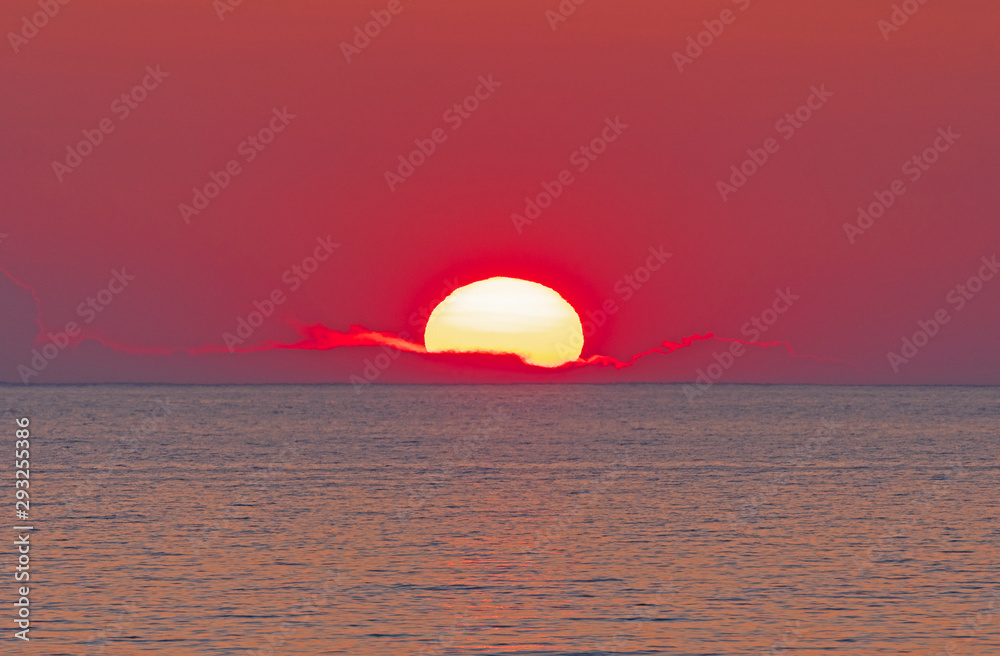 The Sun Setting into a PIllow Of Clouds