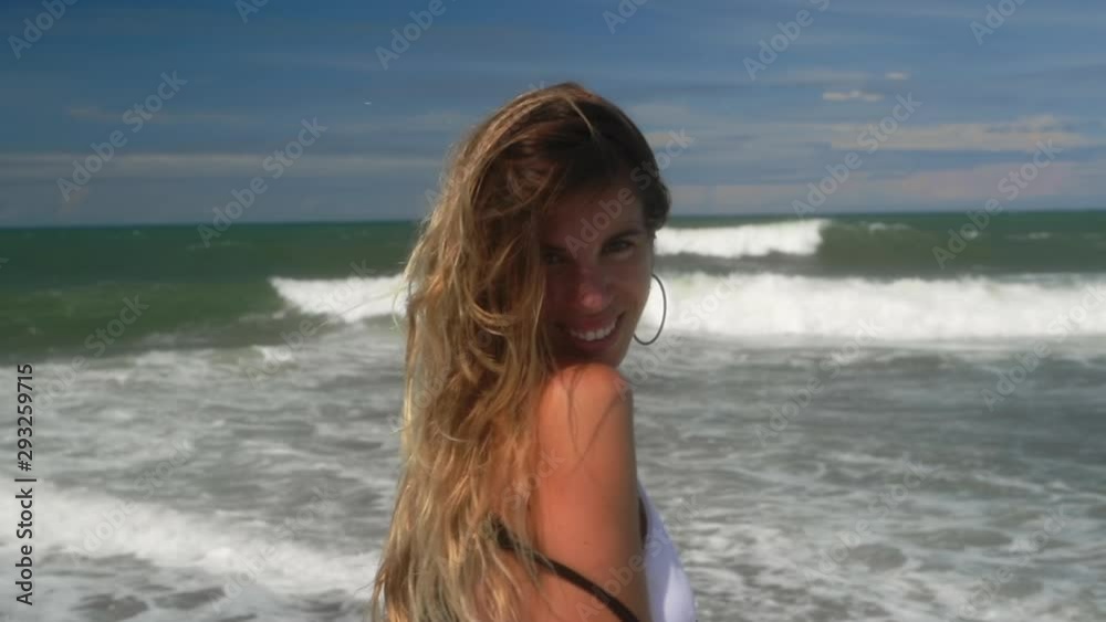Portrait of beautiful young woman in white bikini and light black summer dress. Concept of fitness healthy active living. Slow motion. Sport and travel. Happy smiling lady playful having fun. Portrait of beautiful young woman in white bikini and light black summer dress. Concept of fitness healthy active living. Slow motion. Sport and travel. Happy smiling lady playful having fun.