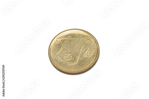 A close up image of a gold Israeli half shekel, shot close up in macro, against a white background