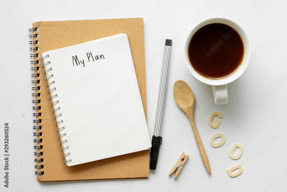 Notebook with My Plan text on top of white notebook with coffee on office desk .Life planning concept. Notebook with My Plan text on top of white notebook with coffee on office desk .Life planning concept.