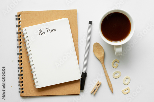 Notebook with My Plan text on top of white notebook with coffee on office desk .Life planning concept.