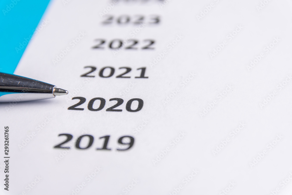 List of recent years on white paper. Pen points at 2020. Copy Space List of recent years on white paper. Pen points at 2020. Copy Space