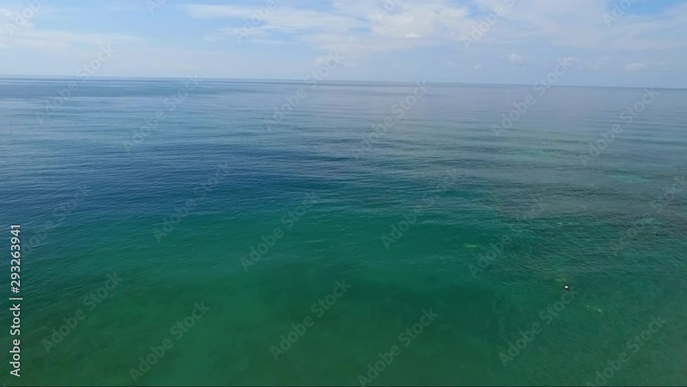 Forward moving birds eye view of the horizon meeting sky and ocean at Amed beach, Bali, Indonesia Forward moving birds eye view of the horizon meeting sky and ocean at Amed beach, Bali, Indonesia