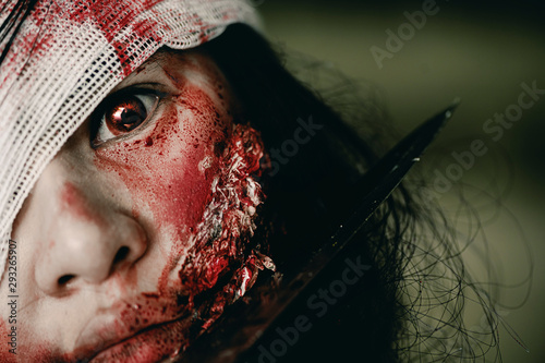 Close-up zombie women looks at her with resentment in an abandoned building, Halloween murder concept.