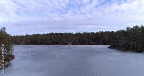 Wallpaper Mural Aerial drone shot at Tresticklan Nationalpark  flying through the virgin coniferous forest with old trees in Swedish winter. Frozen lakes, cracked ice cracks, snow, islands and animal traces, Sweden. Torontodigital.ca