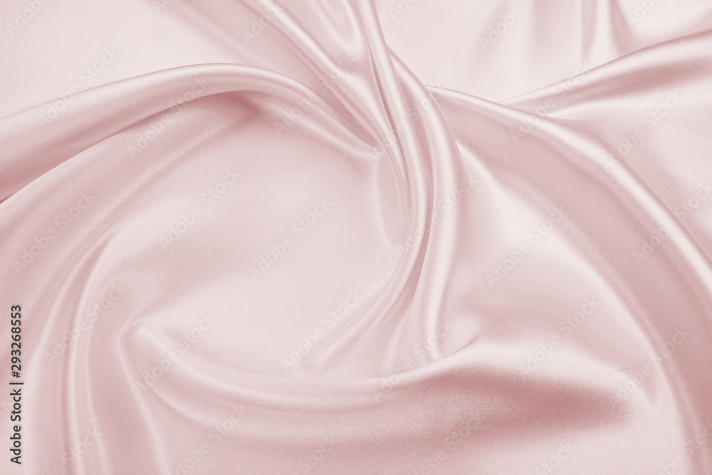 Fototapeta premium Delicate satin draped fabric pink texture for festive backgrounds