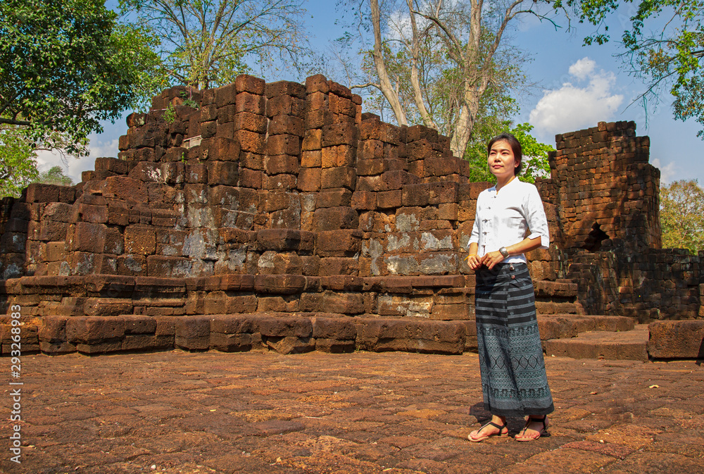 Thai women dressed in traditional costumes walk to visit the ancient sites. Thai women dressed in traditional costumes walk to visit the ancient sites.